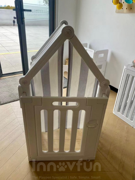 Front view of Innovfun A-frame puppy tent connected to a white Classic playpen